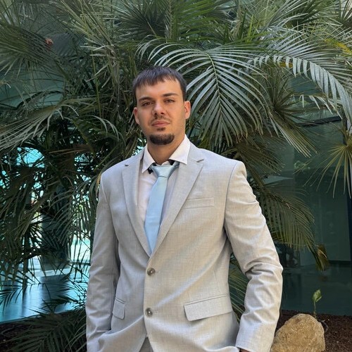 Rubén Toledo con traje gris claro y corbata azul claro